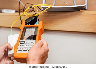 Network Test. Testing Wi fi Internet Speed Connection in Home IT Equipment. Checking Fiber Optic Cables Internet wi-fi Router by Tester Optical Power Meter.  - Shutterstock ID 2378800153