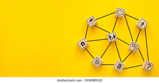 Network. Wooden blocks connected together on a yellow background. Teamwork concept	