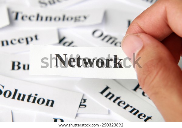 Network word paper in hand with the background of\
other words.