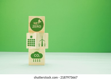 Net-zero emissions in 2050. Save earth and environment, and carbon neutral. Wooden cubes with eco-friendly icons with a green background. World Earth Day concept. Space for text - Shutterstock ID 2187973667