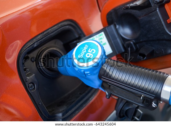 Neuoetting,Germany-May\
19,2017: A car fills up its tank with  Super 95 Octane unleaded\
fuel at a ARAL tank\
station