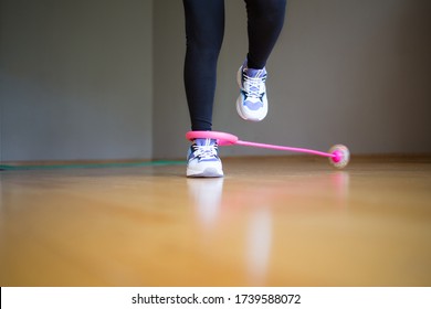 Neuro Jump Rope. Child Plays Sports At Home. Active Lifestyle. Activity For Kids. Feet In Sneakers.