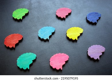 Neurodiversity concept. Multicolored figures of the brain on a dark surface. - Shutterstock ID 2195079195
