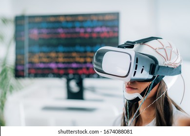 Neuroscience Lab. Patient With Virtual Reality Goggles And EEG Brainwave Cap