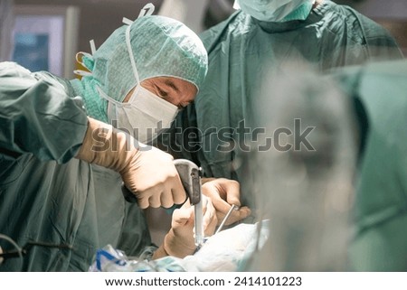 Neurosurgeons opening the cranium during an operation