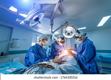 Neurourgeons Are Operating With Medical Robotic Surgery Machine. Modern Automated Medical Device. Surgical Room In Hospital With Robotic Technology Equipment, Machine Arm Neurosurgeon.