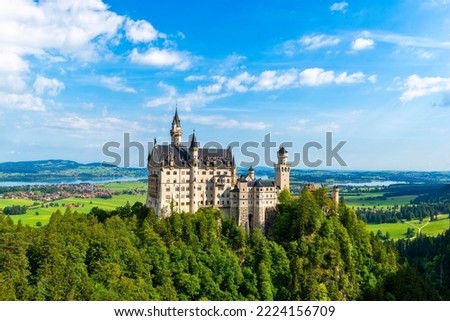 Neuschwanstein castle with its houses, towers and battlements situated on a hill in Allgäu, Bavaria, Germany