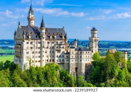 Neuschwanstein castle with its houses, towers and battlements situated on a hill in Allgäu, Bavaria, Germany