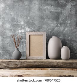 Neutral Colored Vases And Shabby Photoframe On Distressed Wooden Shelf Against Rough Plaster Grey Wall. Home Decor.