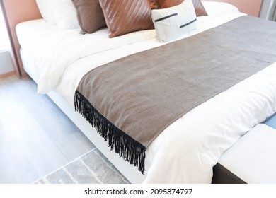 Neutral Coloured Bedroom With Throw Blanket On A Bed.