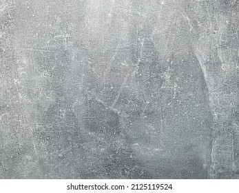 Neutral gray background. Scratched concrete with smears of streaks.