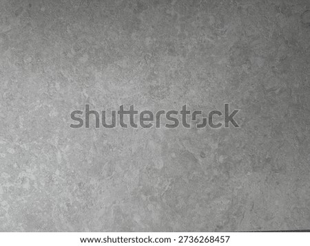 Neutral gray concrete surface with subtle stone texture, soft tonal variations, and matte finish, suitable for modern interiors, minimal design concepts, and architectural backgrounds