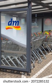 Neuwied, Germany - June 20, 2021: Logo Of The German Retail Drugstore Chain Dm On A Vitreous Divider Wall With Shopping Carts In A Row. 