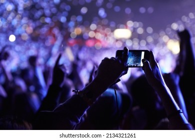 Never Forget This Moment. An Audience Member Taking A Photograph Of The Crowd At A Music Festival.