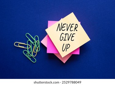 Never give up symbol. Steaky notes with Concept words Never give up. Beautiful deep blue background. Business and Never give up concept. Copy space.