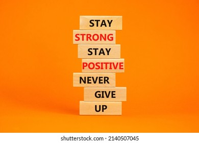 Never Give Up Symbol. Wooden Blocks With Concept Words Stay Strong Stay Positive Never Give Up. Beautiful Orange Background. Copy Space. Motivational Business Never Give Up Concept.