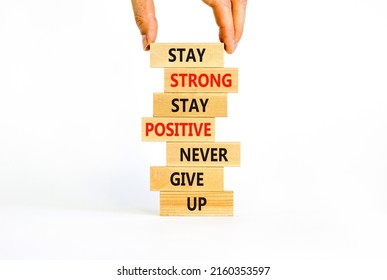 Never Give Up Symbol. Wooden Blocks With Concept Words Stay Strong Stay Positive Never Give Up. Beautiful White Background. Copy Space. Businessman Hand. Motivational Business Never Give Up Concept.