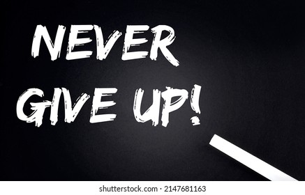 NEVER GIVE UP Text Black Chalkboard and piece chalk