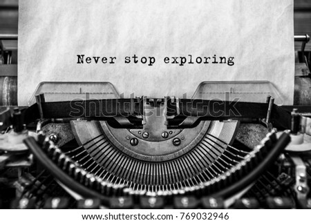 never stop exploring printed on an old typewriter, vintage. close-up. Motivation for success