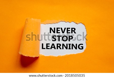 Never stop learning symbol. Words 'Never stop learning' appearing behind torn orange paper. Beautiful orange background. Business, educational and never stop learning concept, copy space.