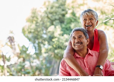 Never stop playing. Shot of a carefree senior couple enjoying a piggyback ride outdoors.