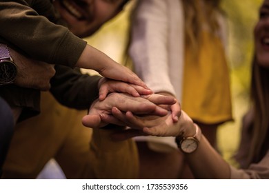 Never underestimate the importance of support. Parents spending time with their children outside. Focus is on hands. - Shutterstock ID 1735539356