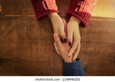 Never Underestimate The Power Of A Kind Gesture. Cropped High Angle Shot Of An Unidentifiable Man And Woman Holding Hands On A Table.