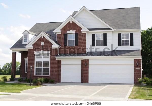 New 2 story brick\
home with 3 car garage