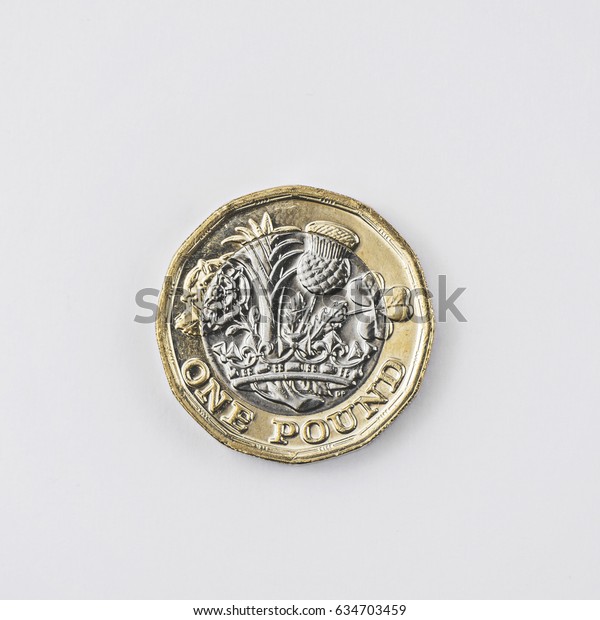 New 2017 UK one pound coin shot from above in\
studio on a white\
background.