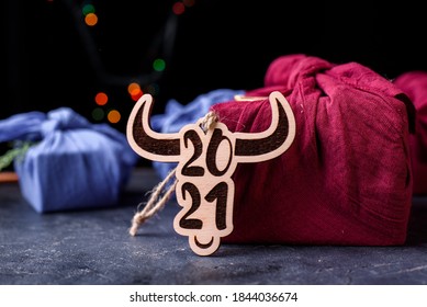 New 2021 is a bull. A wooden toy on the Christmas tree in the form of a symbol of the new year. Eco toys. New Year's content