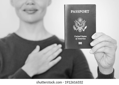 A New American Citizen Holding A USA Passport And Pledging Oath At The American Embassy Office. Emigration And Citizenship.