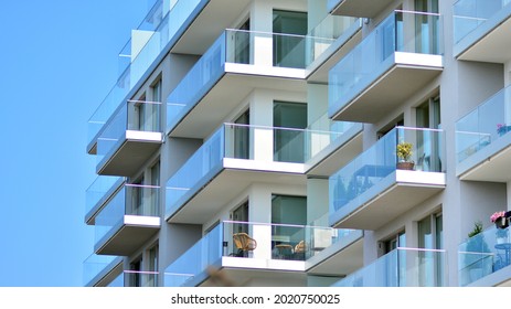 New Apartment Building With Glass Balconies. Modern Architecture Houses By The Sea. Large Glazing On The Facade Of The Building.