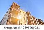 New apartment building. Residential area with modern apartment building. in sunny day. Fragments of the wooden facade.
