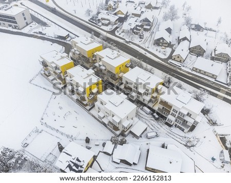 New apartment buildings in winter. Covered in snow. Drone aerial view