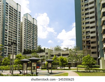 A New Apartment Neighborhood With Carpark And Playground.