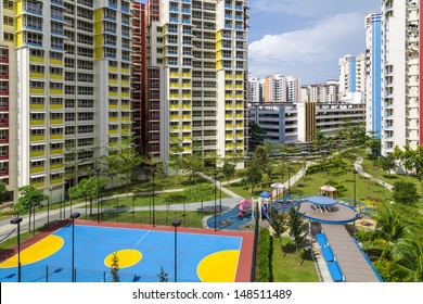 A New Apartment Neighborhood With Carpark And Playground.