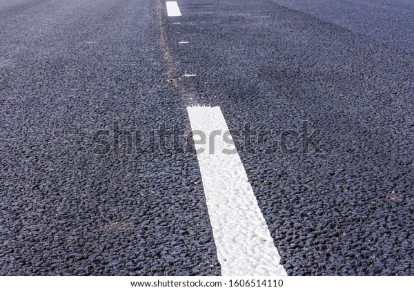 New asphalt road\
with white dividing strip