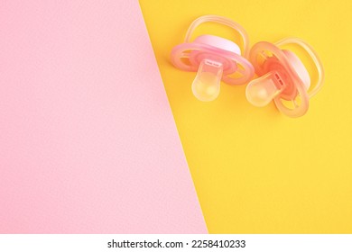 New baby pacifiers on color background, flat lay. Space for text - Shutterstock ID 2258410233