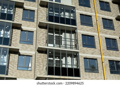 New Balconies In Building. New House In City. Exterior Of Apartment Building. Wall Covering. Plastic Windows.