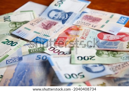 new bank notes of mexican peso background. 100, 200, 500, 1000 pesos