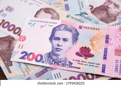 New banknote of 200 hryvnia against the background of 1000 hryvnia banknotes. Financial concept. - Shutterstock ID 1793418223