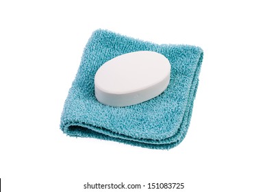 New Bar Of White Soap On A Blue Washcloth Isolated On A White Background