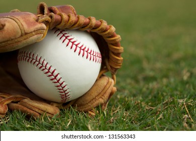 New Baseball In A Glove On The Grass