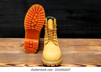 New beautiful brown yellow warm mountain women's winter Timberland tracking shoes, boots, sneakers, trainers logo on wooden background. Sport casual footwear concept. - Shutterstock ID 2216542637