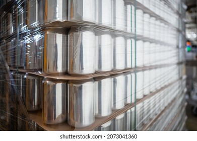 New Beer Cans Stacked In Warehouse. Empty Aluminum Can Storage In Brewery