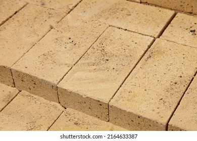 New Beige Fire Proofing Bricks Close Up In Stack. Brickwork Building Materials Manufacturing Storage And Retail.