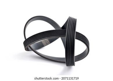 A new belt for a poly-V-ribbed electric generator. Car timing belt. White background close-up. Selective focus