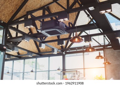 New Black Air Conditioning Vent On Ceiling Modern Restaurant, Inside Background. Heavy Ceiling Air Conditioner Decoration In Loft Style Office. Cassette Type Air Conditioner With Vintage Ceiling Lamp