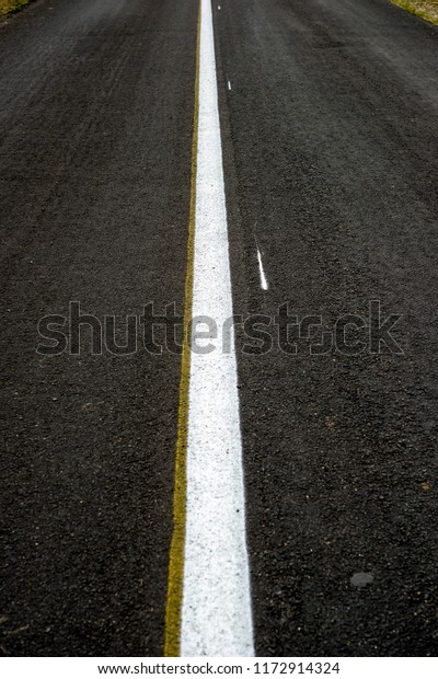 New black
asphalt road with white dividing
strip