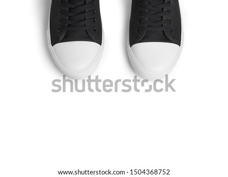 New black Classic gumshoes on a white background. Top view of half sneakers, black gumshoes with white soles.
